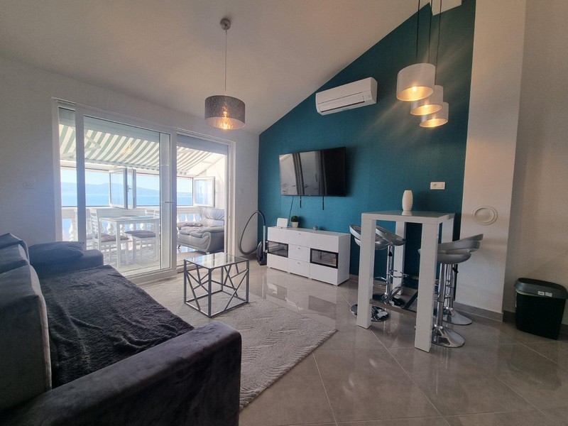 Nappali modern bútorokkal és benzinkék falú.