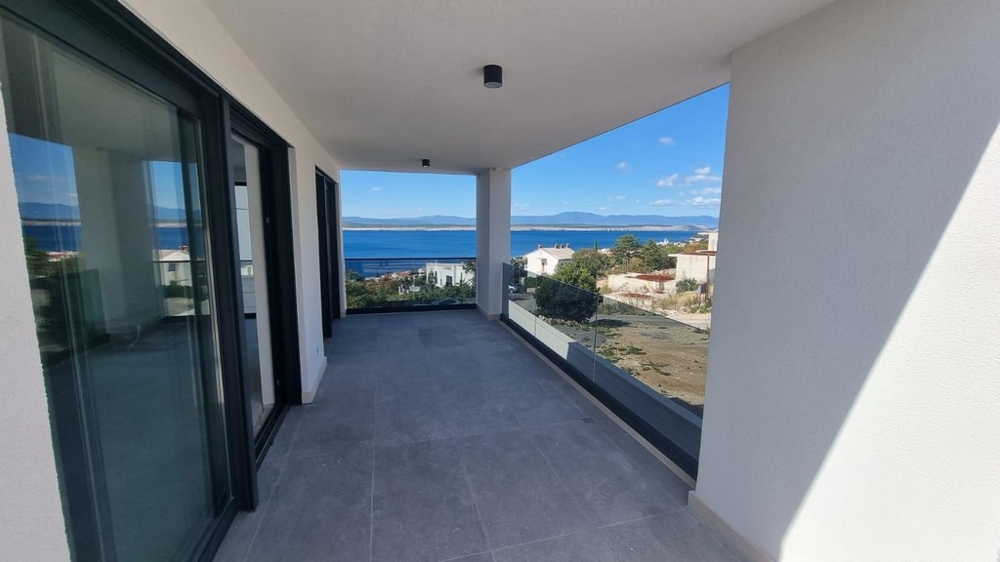 Egy modern apartman fedett terasza Horvátországban, kilátással a tengerre és a környező területre.