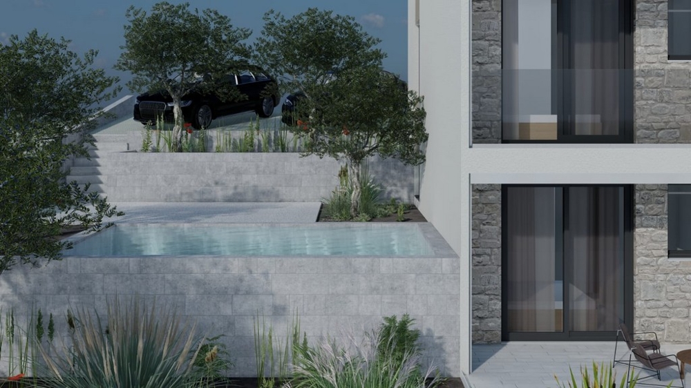 Medence az épület előtt zöldövezettel és parkolóhelyekkel