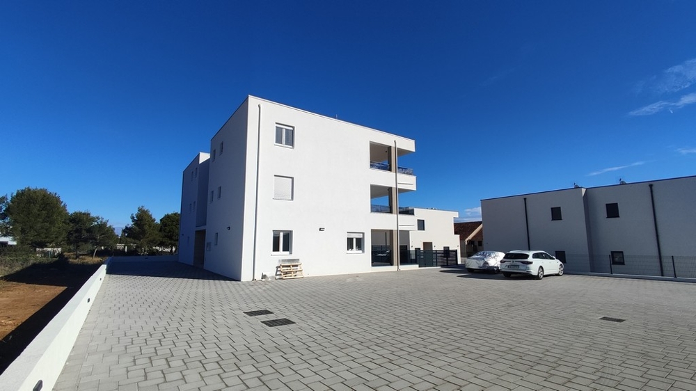 Külső kilátás modern lakóépület parkolóhelyekkel