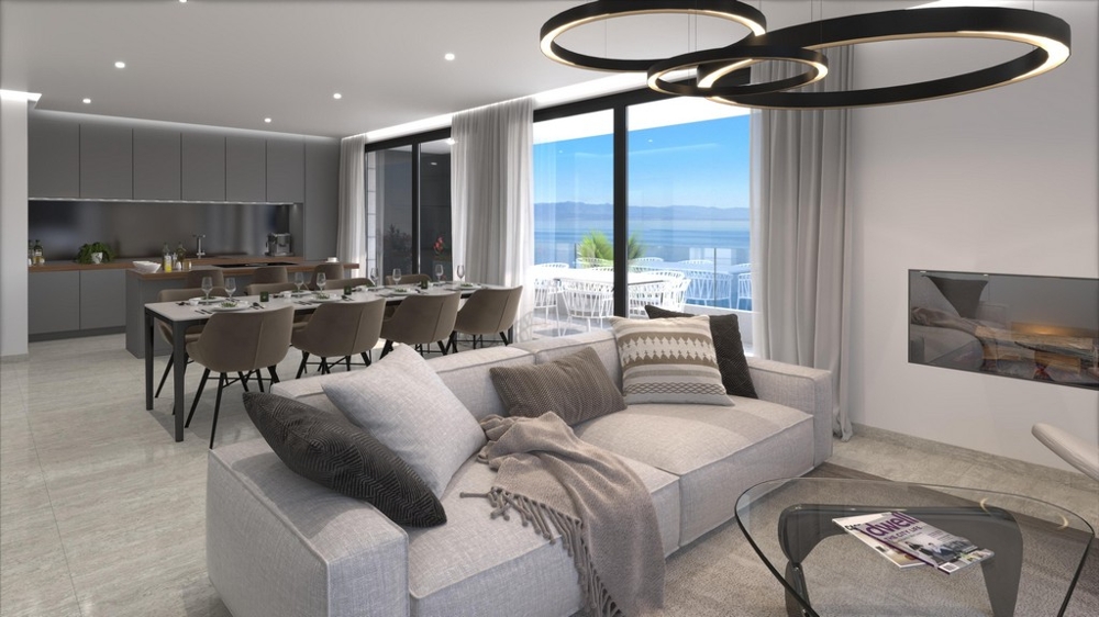 Nyitott terű nappali és étkező, konyhával és tengerre néző kilátással