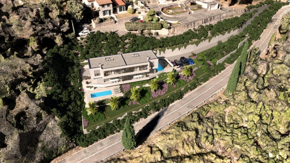 Az ingatlan légi felvétele épületekkel és medencével