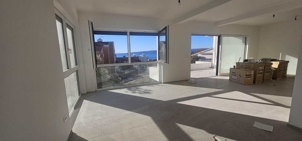 Nappali nagy ablakokkal és kilátással a tengerre