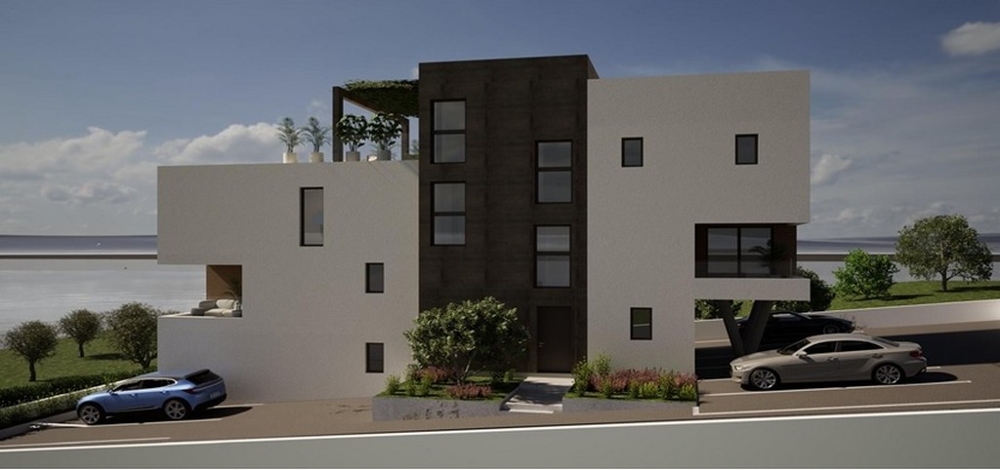 Utcára néző modern új épület parkolóhelyekkel