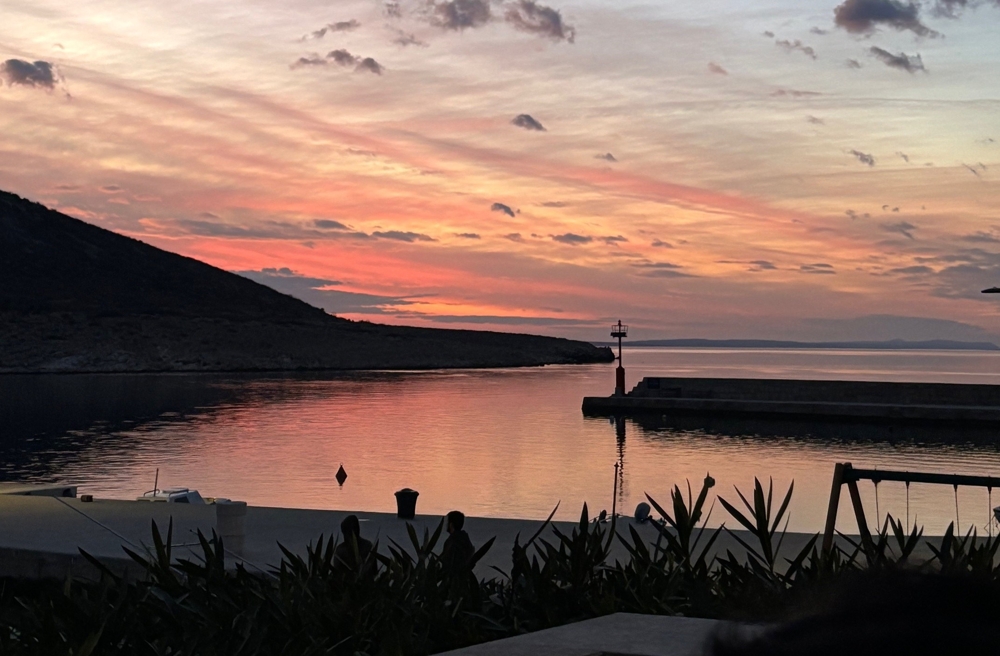 Kikötőre néző naplementekor a tenger mellett