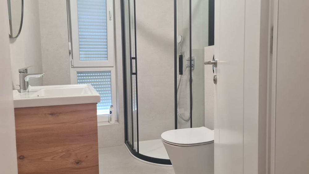 Fürdőszoba zuhanyzóval és WC-vel