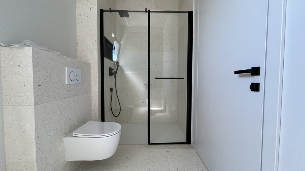 A vodicei penthouse fürdőszobája zuhanyzóval és WC-vel
