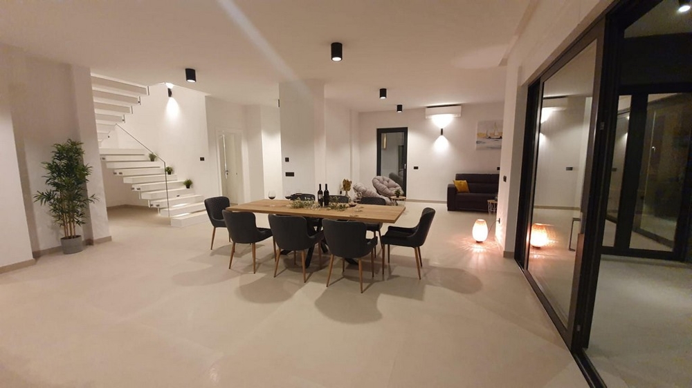 Nyitott terület étkezőasztallal és kilátással a lépcsőházra.