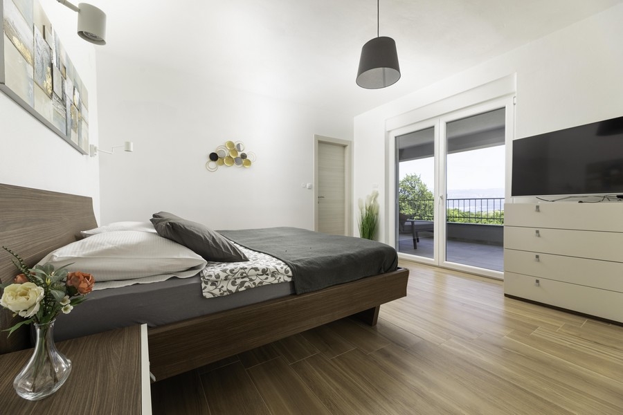 Ezen a képen a Krk szigeten eladó H2400 ingatlan vonzó és kényelmes hálószobája látható.