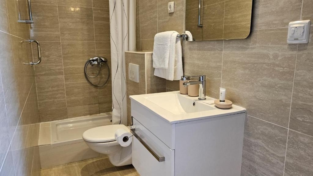 Fürdőszoba ablakkal és zuhanyzóval