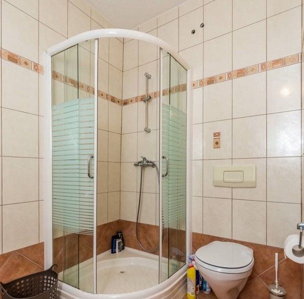 Egy horvátországi ingatlan fürdőszobája sarokzuhannyal és WC-vel
