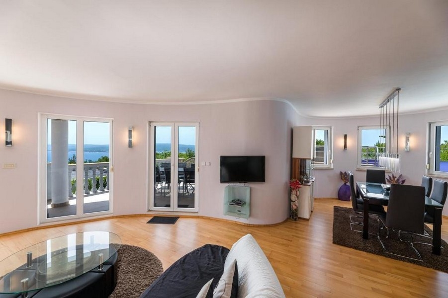 Egy horvátországi bérház nappalija nyitott alaprajzú, kijárattal a tengerre néző teraszra