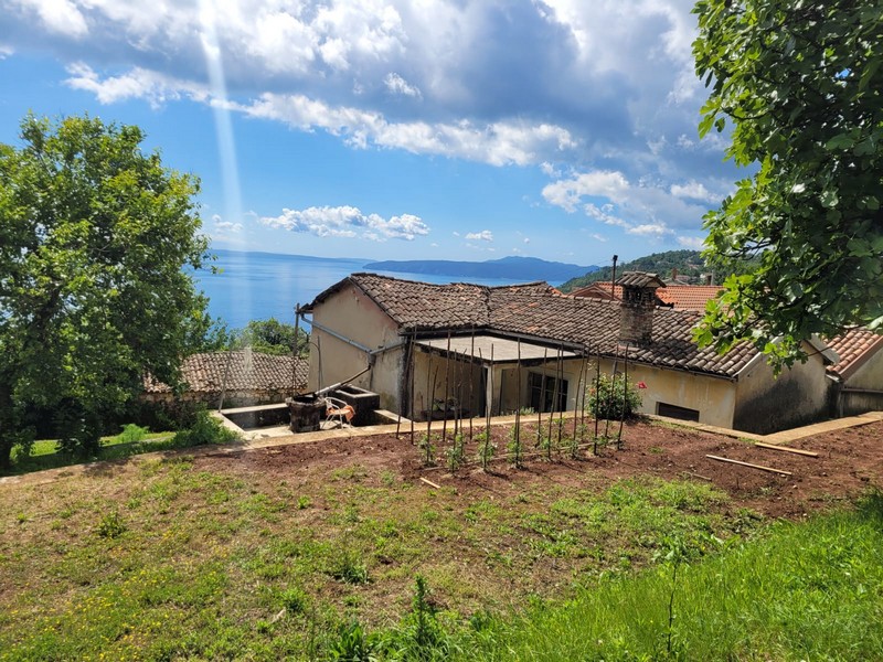 Az ingatlan áttekintése régi kőépületek és nyitott terek keverékével, ideális horvátországi ingatlanbefektetéshez.