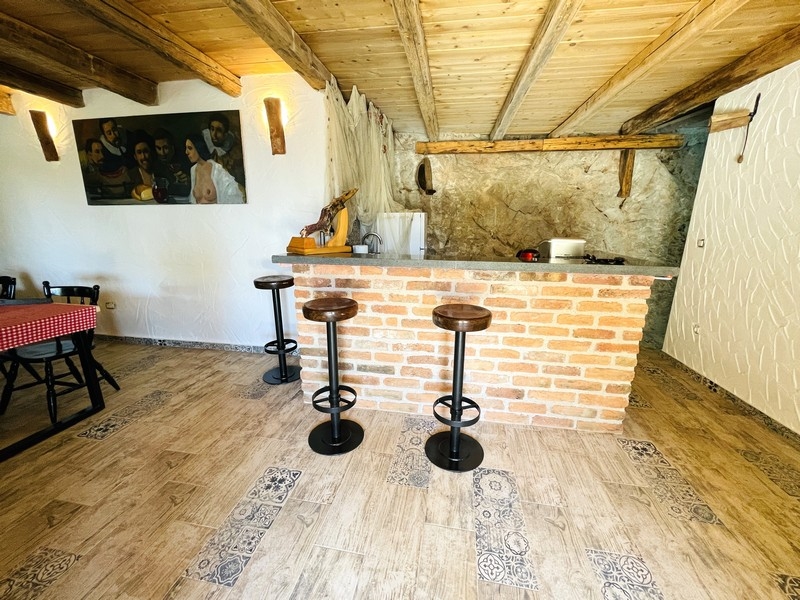 Rusztikus taverna téglából készült bárpulttal, fagerendás mennyezettel és bárszékekkel