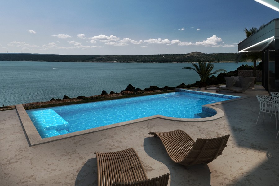 Medence (világított), panorámás kilátással a tengerre.