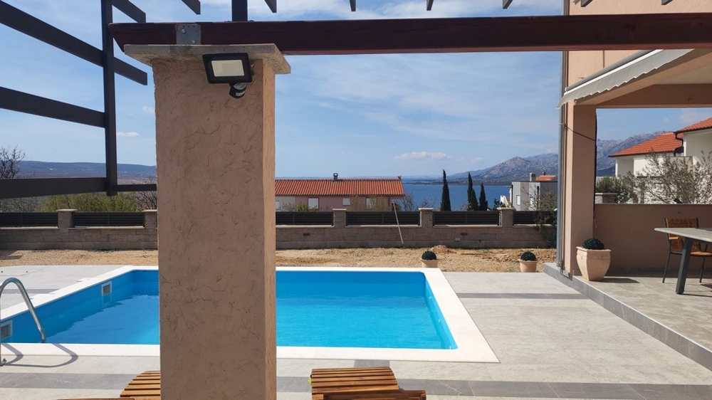 A teraszról kilátás nyílik a medencére és a tengerre