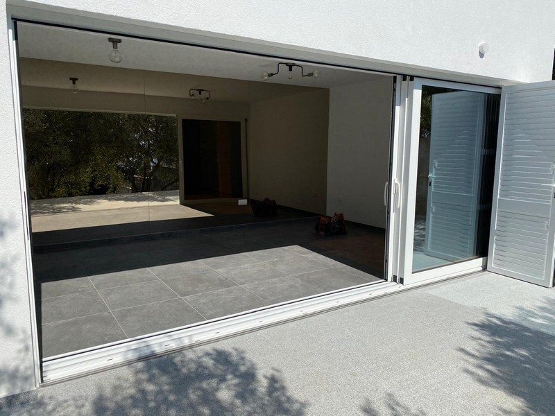 Tágas nappali tolóajtókkal a teraszra