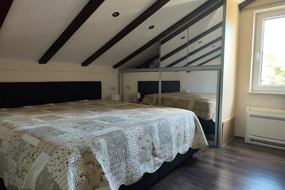 Tetőtéri hálószoba fagerendákkal