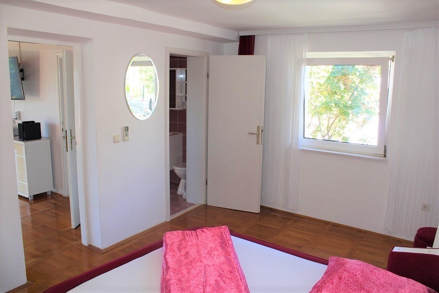 Hálószoba hozzáféréssel a fürdőszobához, kilátással a növényzetre