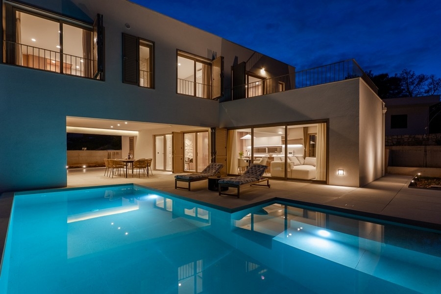 Megvilágított villa medencével alkonyatkor