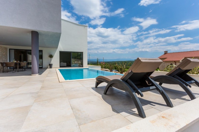 A Villa H934 napozóterasza és úszómedencéje Krk-n, Horvátországban.